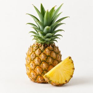 A small pineapple and a cut wedge